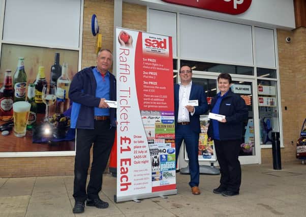 Michael Holmes is campaigning to get defibrillators installed around Mansfield, pictured from left are One Stop shift manger Ian Eadson, Michael Holmes and shift manager Zara Byer