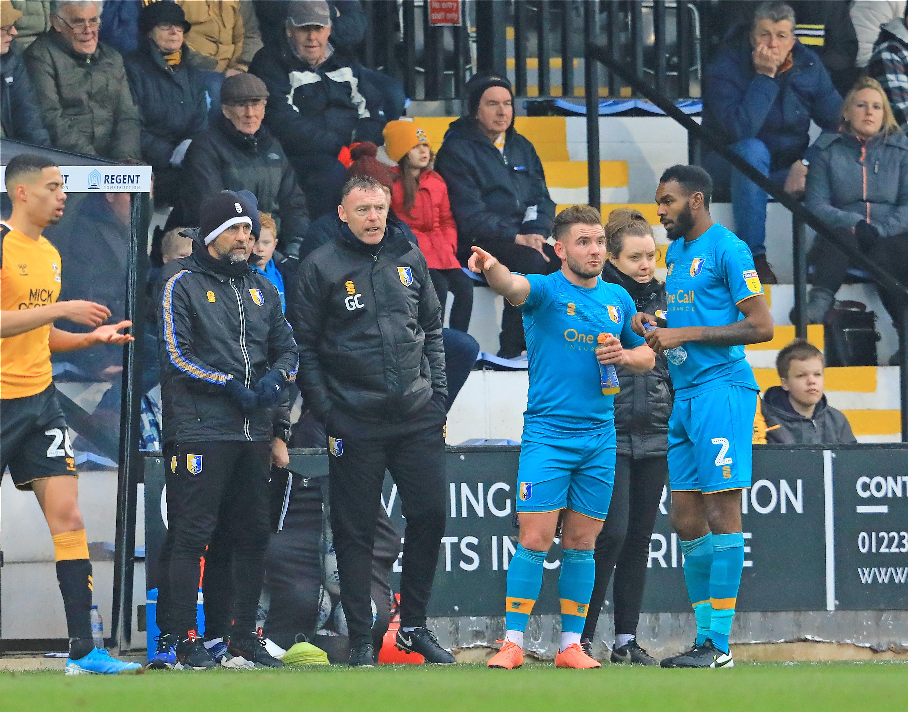 Mansfield Town midfielder Alex MacDonald (7) discussing with Mansfield Town defender Hayden White (2)