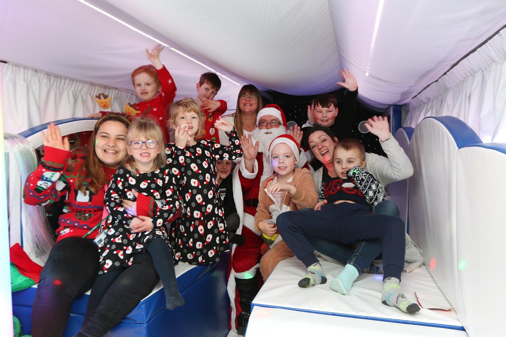 West Park Academy's special needs children meet Father Christmas in the new bus, something they couldn't do at a traditional grotto 