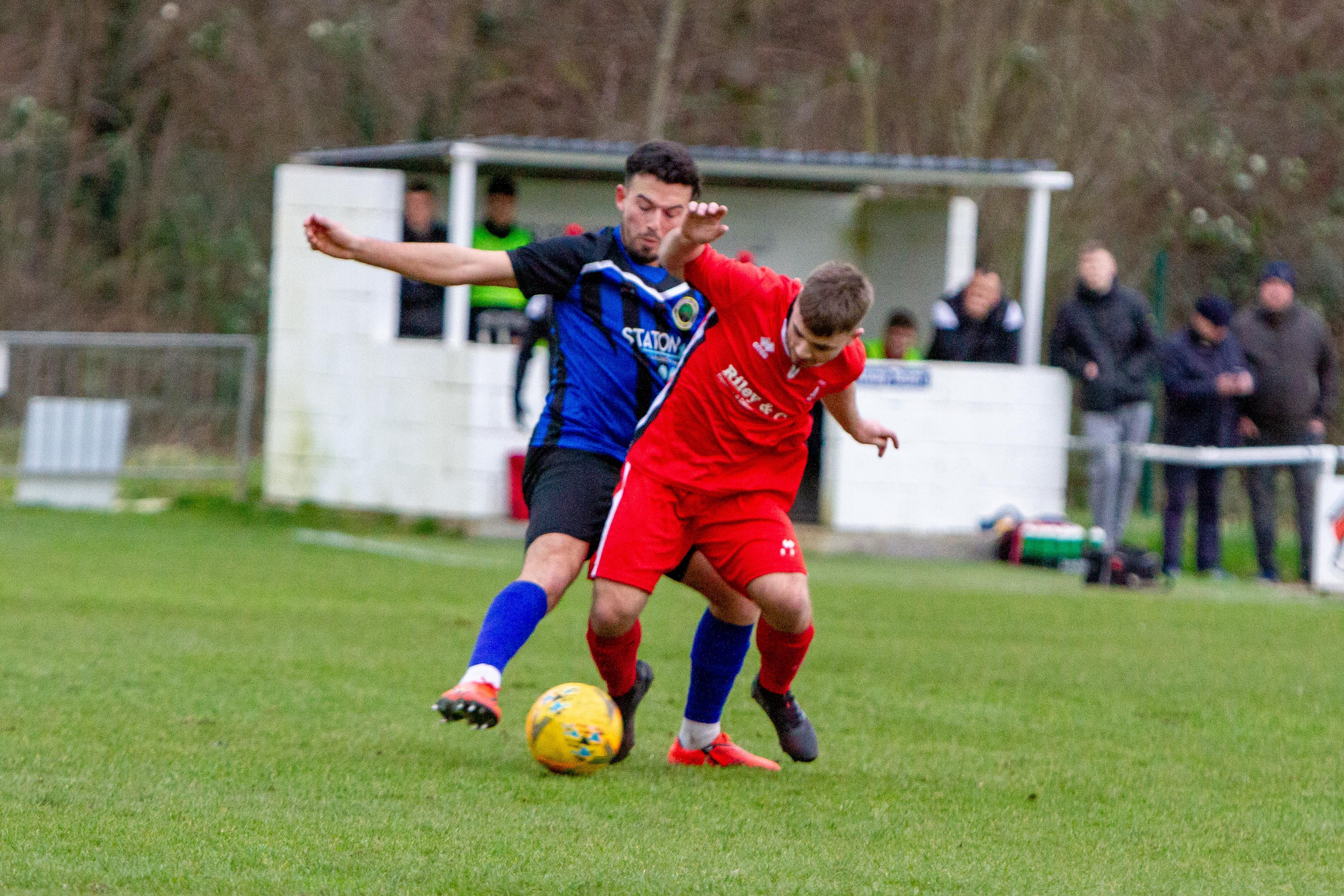 A midfield tussle in the local derby between Sherwood Colliery and Clipstone (red).