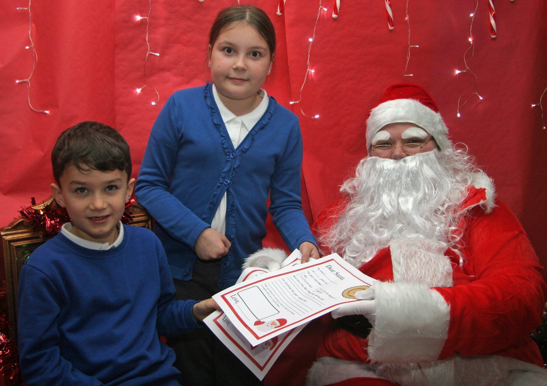 Joshua and Gracie Brown hand their letters to Father Christmas.