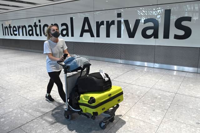 Passengers wearing a face mask or covering due to the pandemic, arrive at Heathrow airport (Getty Images)