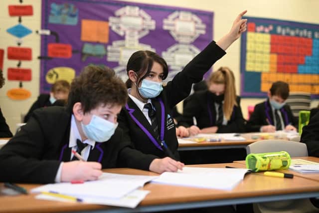 Schools have been advised to hold lessons outside. (Photo by OLI SCARFF/AFP via Getty Images)