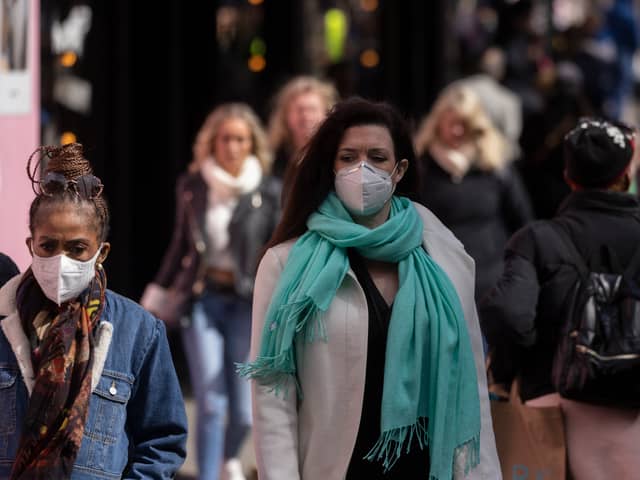 A woman wears a face mask while walking on Oxford Street durng the height of the coronavirus pandemic.