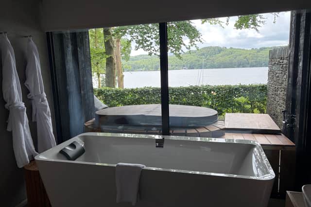 Even the bathroom makes the most of the lake views, with a freestanding bath, built-in TV and outlook towards the private hot tub