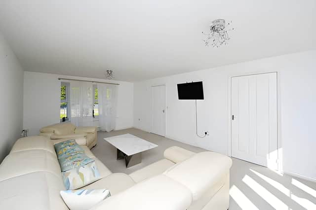A bright lounge is centred around a striking bay window, creating a welcoming main reception space