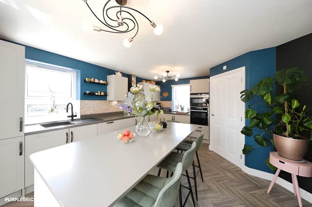 An upgraded contemporary kitchen takes centre stage with a striking island