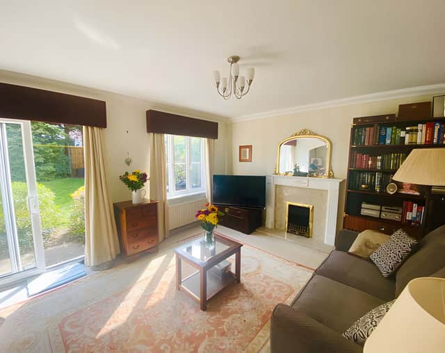 The lounge opens through an archway to the dining room, while French doors connect the reception space with the rear garden.