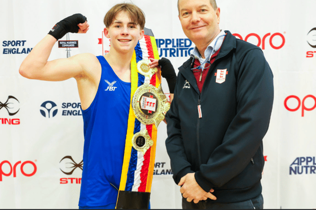 Logan receives National belt from England official  