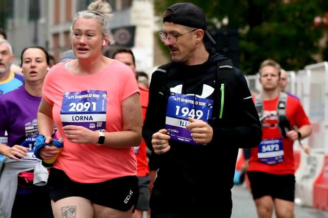 Elllis Collins is pictured motivating a client at Sheffield 10k