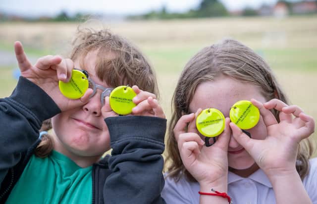Pupils having fun with the donated bag tags