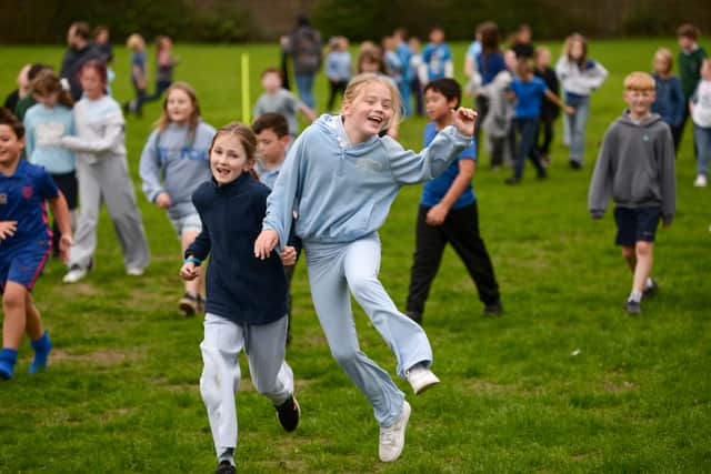 Children wearing blue for their charity fun run at Leamington Primary Academy in Sutton.