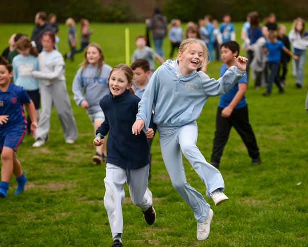 Children wearing blue for their charity fun run at Leamington Primary Academy in Sutton.