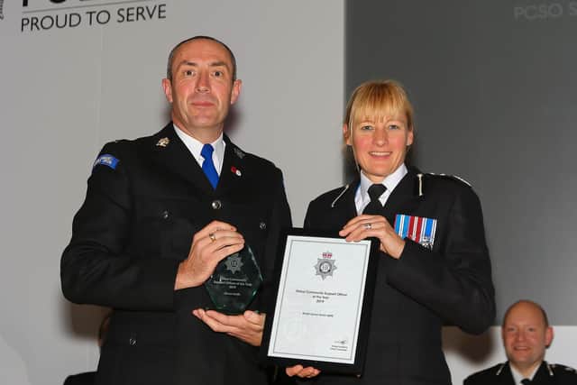 PCSO Simon Smith receives his award from Deputy Chief Constable Rachel Barber.