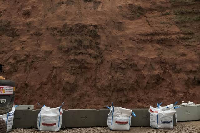 Barriers at the base of the cliff face.
