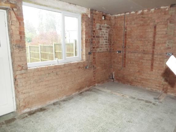 The kitchen gets plenty of light from the large rear window with a view of the garden.