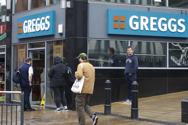 Customers form a socially-distanced queue outside Greggs on Merrion Street, Leeds, as it reopens its doors
