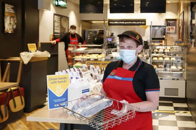 An employee wearing a mask at the Merrion Street branch of Greggs in Leeds. All colleagues have been provided with PPE