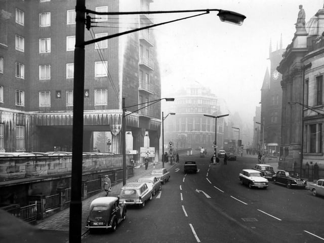 Bishopgate Street showing the Queen's Hotel and the entrance to the City Station on the left. City Square is in the background with the Norwich Union Building in the centre. Pictured in January 1964.