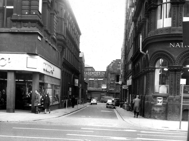 Looking along Alfred Street from Boar Lane in May 1966. On the corners are Dunn & Co., hatters, left, and the National Provincial Bank, right. Pictured in May 1966.