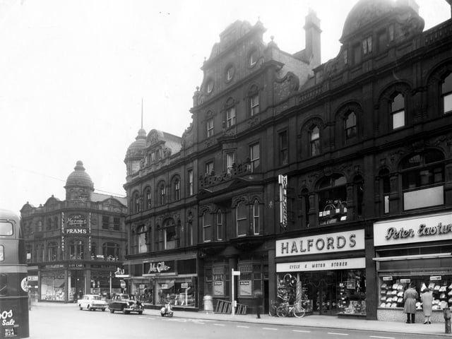Vicar Lane. On the left, the premises of Siller Ltd, pram and baby car manufacturers. Moving right is the entrance to King Edward Street, then John Collier's menswear. In the centre is the former Dolphin Inn.
