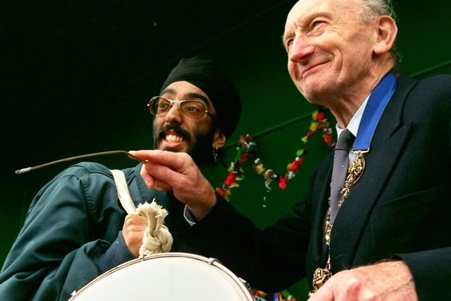 Jotinder Singh teaches the Mayor of Preston, Coun Geoff Swarbrick to play the drums at the Preston Mela Festival