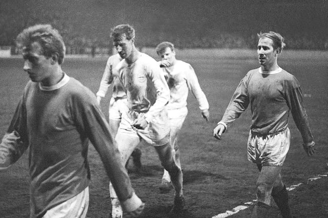 Big Jack walks off the pitch at the side of brother Bobby after Leeds United had drawn 1-1 with Manchester United at Elland Road in January 1966.
