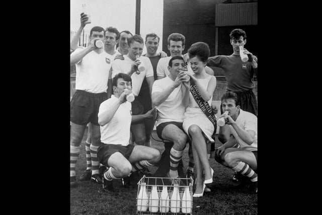 Preston North End players, who drink 32 pints of milk between them everyday, pose with Morcambe Milk Maid Vivki Wood who is sat on the knee of centre forward Alex Dawson. Preston North End say they will drink to victory with milk should they win the FA Cup. They meet West Ham United in the FA Cup Final at Wembley Stadium.