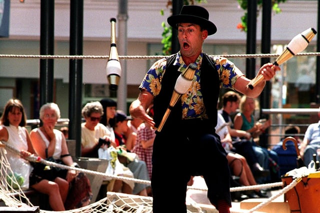 Pete White of Pete White's Suitcase Circus entertains shoppers in Central Square, Lands Lane in August 1997.