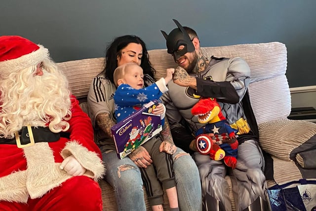 Batman and Santa Clause visited Ellis and family.