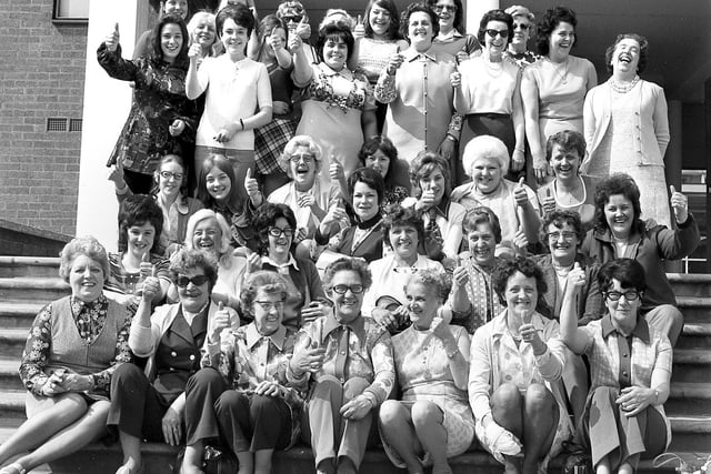 Sunny smiles as staff from Wigan's Woolworths store gather together for an Observer photograph, before setting off for a day trip to Blackpool.