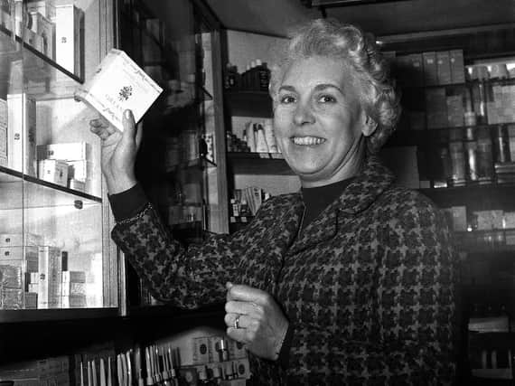 Mrs Eileen Boon in the well stocked perfume department at Boon's Chemist on Wigan's  Market Street in 1967.