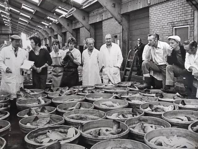 Fish merchants gather round for the fish auction which was the last of fish caught by middle-water vessels in Fleetwood, July 1982