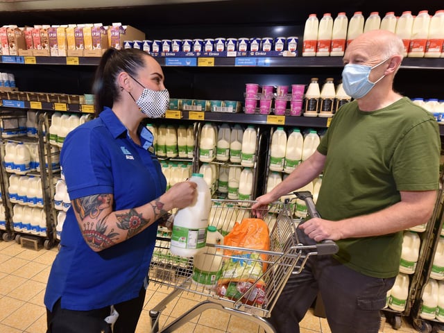 Claudia Vallily helps customer Ray Goodall.