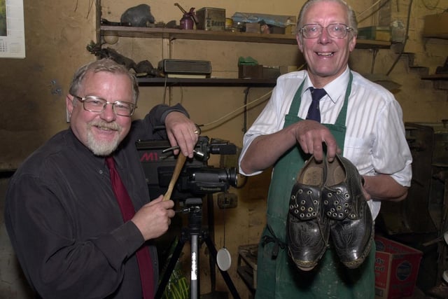 Walter Hurst, right, with Geoffrey Shryhane, local journalist, makes a video documentary of Walter Hurst and Son, clog maker, before the shop closed down September 2001.