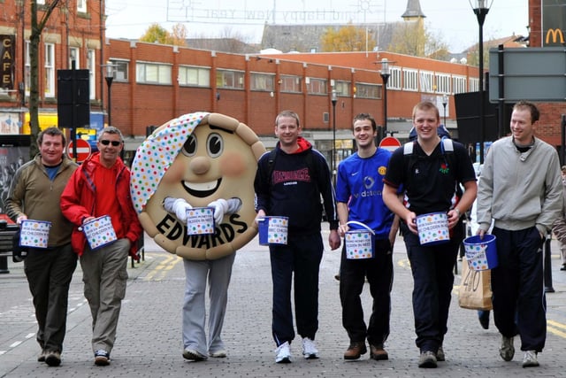 Staff at Edwards Bakers took part in a charity walk, taking turns dressed as a giant pie over the 20 mile course from the Delicatessen in the Royal Arcade, Wigan, to BBC Manchester in aid of Children in Need. from left,  Damian Ratchford, Steve Williams, The Pie,  Duncan Edwards, Sam Ratchford, Ben Flynn and Mark Hindley, walking on Standishgate in 2009.