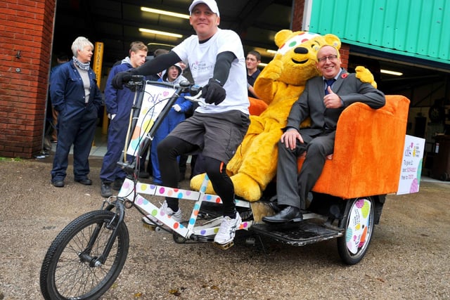 Ian Tomlinson, project director of Fix-it UK, back right, meets Children in Need mascot Pudsey Bear and DFS staff member Stephen Tandy, left, as part of the charity cycle organised by DFS, to raise funds for Children in Need in 2013.