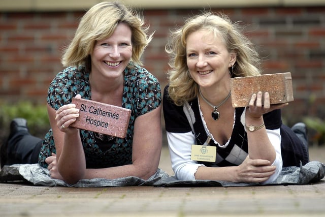 Fundraisers Louise Leah and Jane Richardson in the brick courtyard.