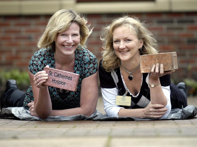 Fundraisers Louise Leah and Jane Richardson in the brick courtyard.