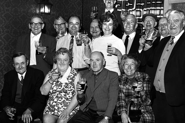A group of pub regulars at the Church Tavern in Parr, with landlords Allan and Winnie Bridge , standing centre