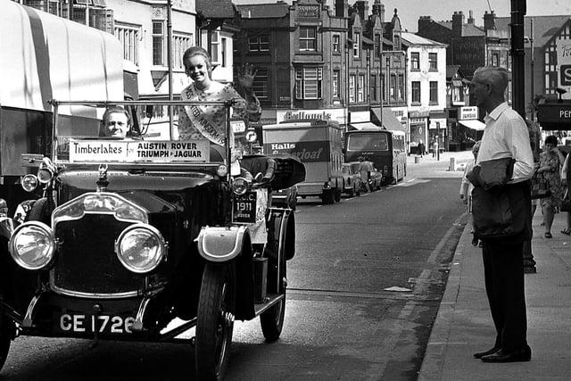 Miss United Kingdom Yvonne Ormes arrives in Wigan's Standishgate aboard a 1911 Rover car to promote Timberlakes main dealership in 1971