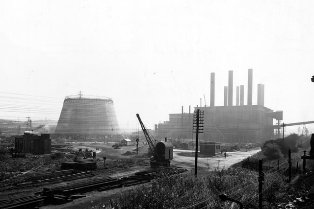 Construction of the cooling tower at Kirkstall Power Station in August 1945. A crane and train line are pictured in the foreground.