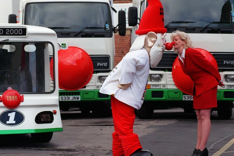 Mags McAvoy of M.D.Foods in Leeds greets the official Comic Relief Millennium Gnome with an Eskimo kiss on his arrival in the city. The firm took delivery of 5,000 red noses for their employees.