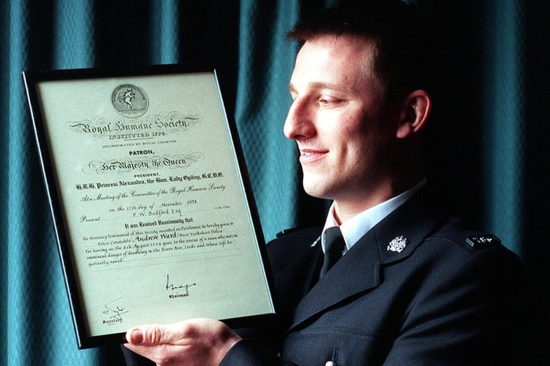 PC Andrew Ward admires his commendation at Milgarth after saving a drowning man from the River Aire.
