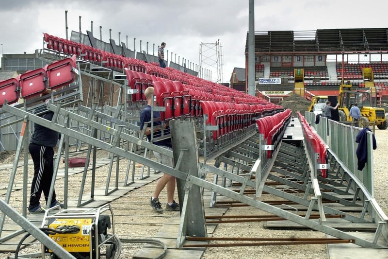 The new temporary seating for the East Stand at Bloomfield Road is being assembled as the old South Stand comes down