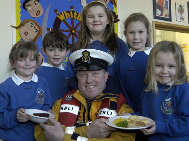 Lifeboat coxswain Mike Russell is served up a treat by Stakesby School pupils.