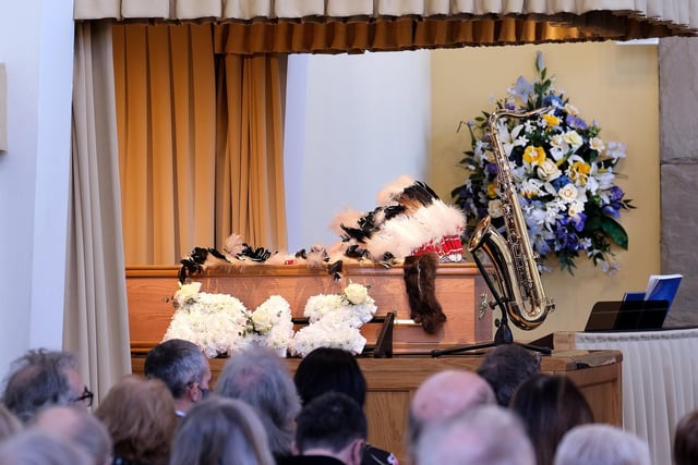 Barry's headdress and saxophone lay with the coffin.
