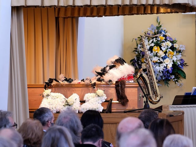 Barry's headdress and saxophone lay with the coffin.