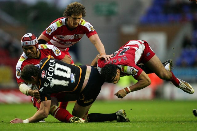 WIGAN, UNITED KINGDOM - 12 JULY 2007:  Jamie Peacock of Leeds is tackled by Harrison Hansen of Wigan during the Engage Super League match between Wigan Warriors and Leeds Rhios at the JJB Stadium on July 12, 2007 in Wigan, England.