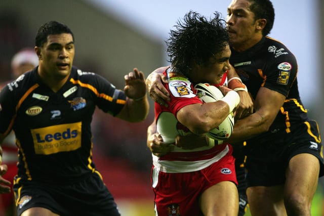 WIGAN, UNITED KINGDOM - JULY 12:  Thomas Leuluai of Leeds is tackled by Brent Webb and Clinton Toopi of Leeds during the Engage Super League match between Wigan Warriors and Leeds Rhios at the JJB Stadium on July 12, 2007 in Wigan, England.